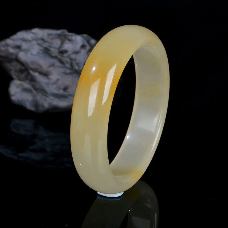 Natural light jade bracelet with polished surface in traditional Chinese style showing size options