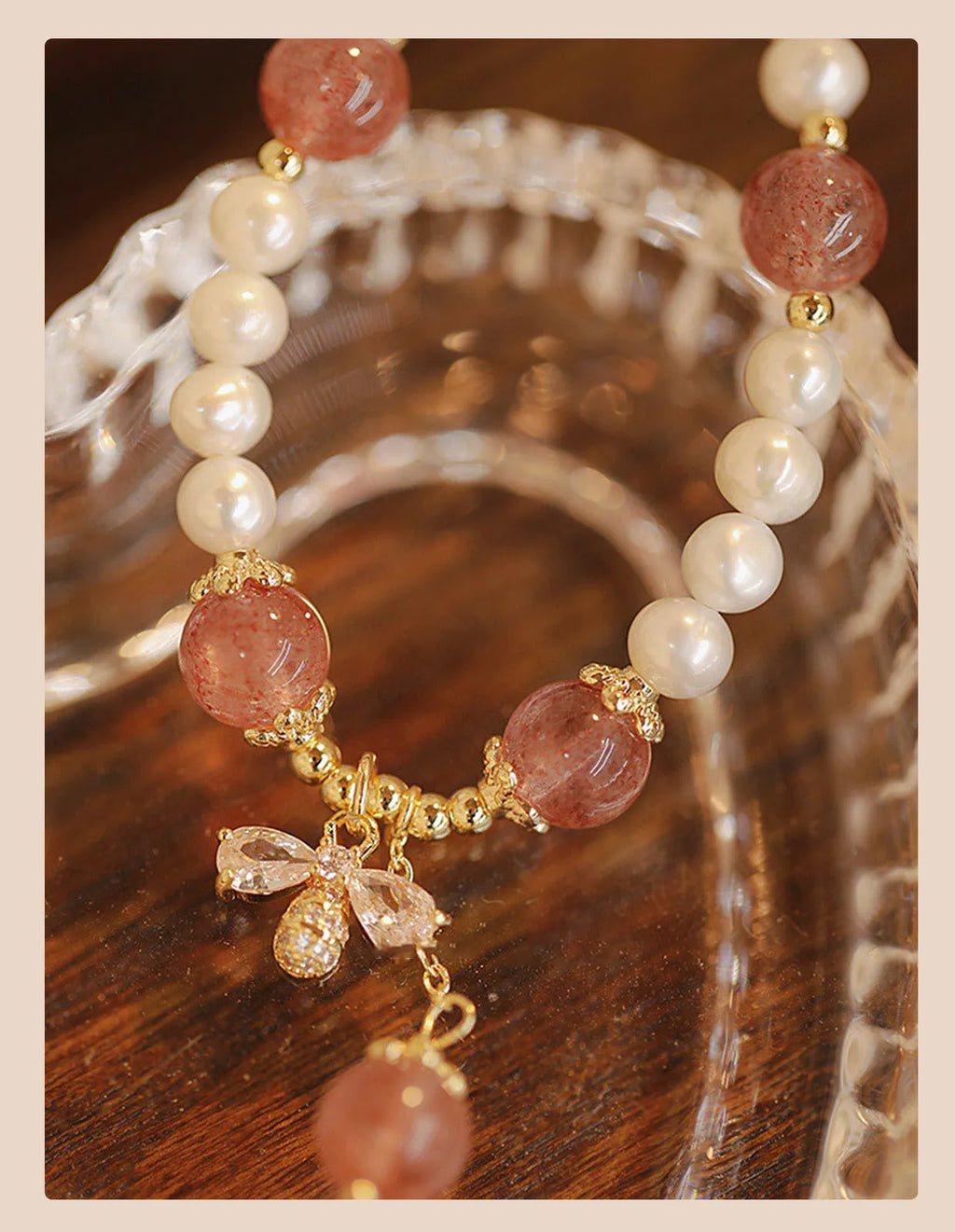 INS style women's crystal bracelet with strawberry quartz stones and a central bow detail.