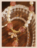 INS style women's crystal bracelet with strawberry quartz stones and a central bow detail.