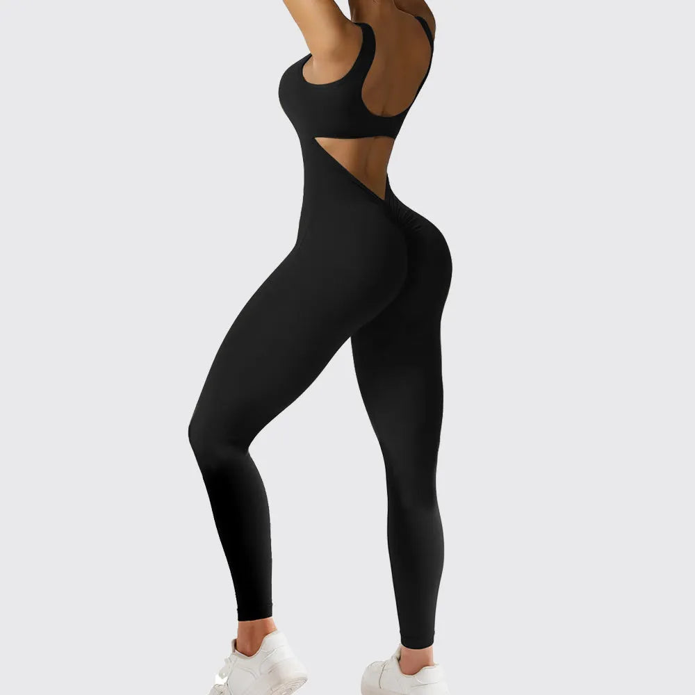 Woman wearing a sleeveless army green flare-leg jumpsuit for yoga or casual wear.