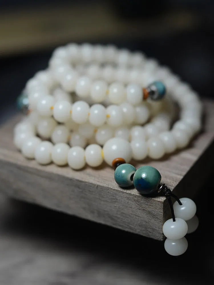 White bodhi seed bracelet with 108 flat round beads in two sizes
