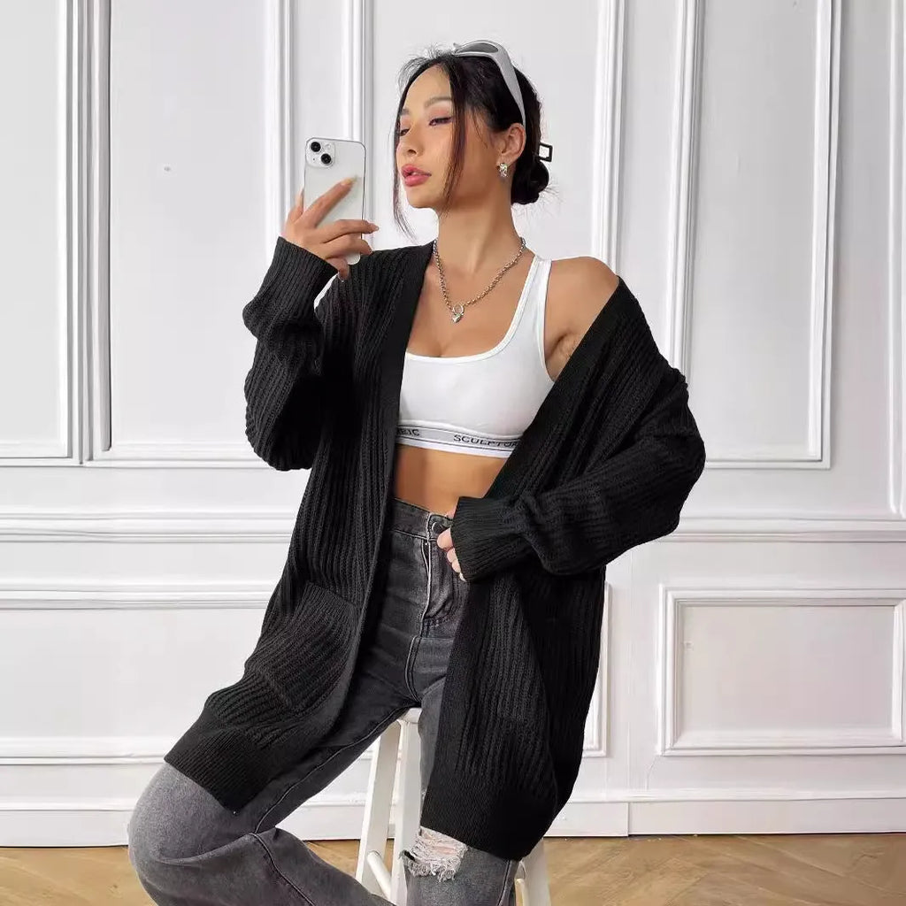 Women's mid-length loose-fit acrylic cardigan in dark green, shown as a single piece with long sleeves.