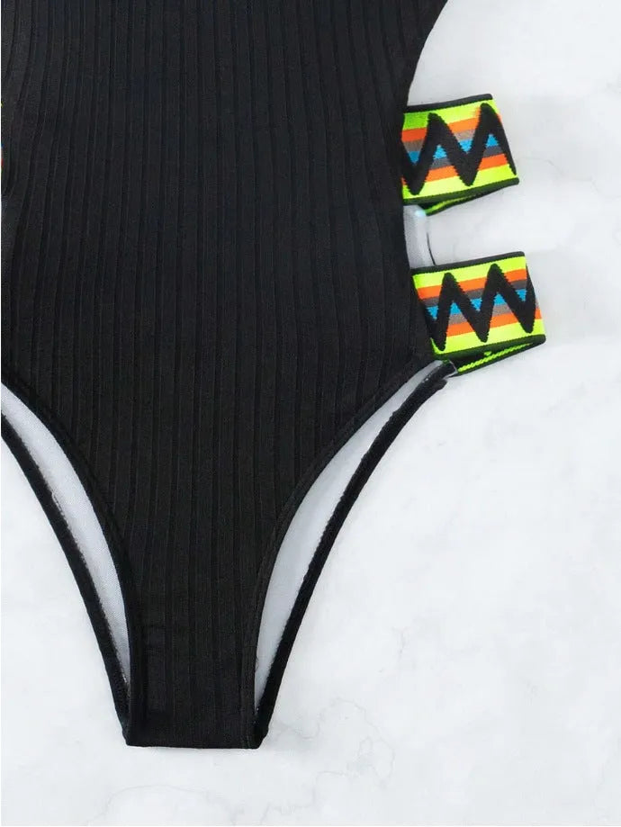 Women's black and orange solid colour one-piece polyester swimsuit on hanger