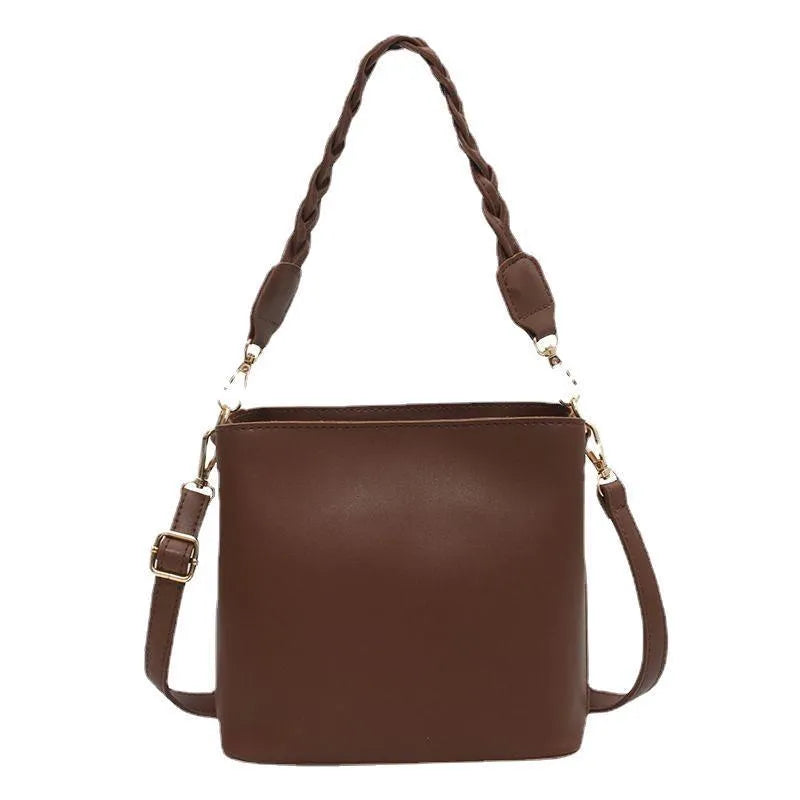 Retro woven PU leather crossbody bucket bag in khaki colour showing adjustable strap and bucket shape
