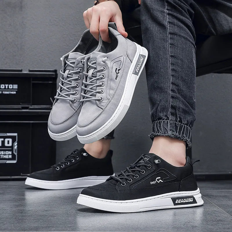Grey men's canvas lace-up sneakers with stitching detail and a low-top round toe design.