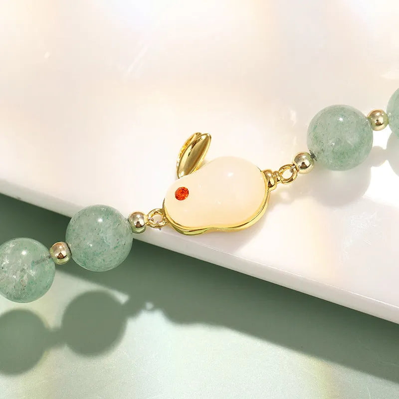 Natural stone rabbit bracelet with green aventurine and strawberry quartz beads, copper plating and gold accents