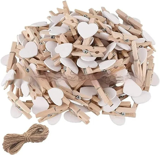 Set of five handmade solid wood heart-shaped clips in red, pink, white, and yellow on a wooden surface.