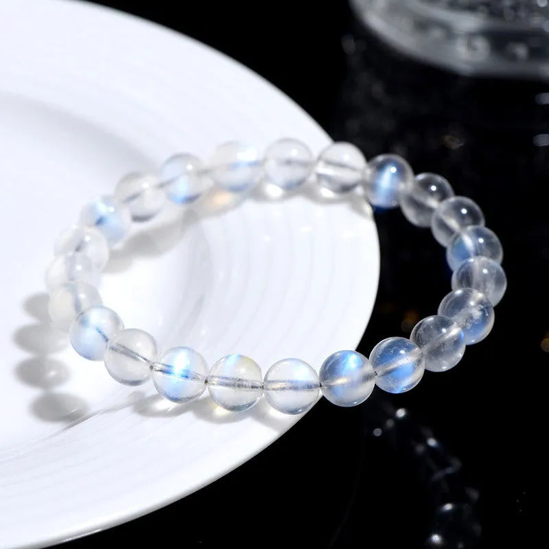 Natural cream coloured crystal bracelet on a wrist showing its simple unisex design and smooth ground beads.