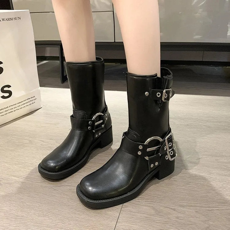 Black women's platform boots with a belt buckle detail on the shaft, shown in mid-calf length.