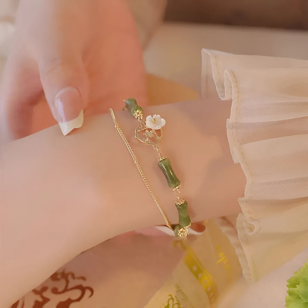 Handmade olivine bracelet with double layer design and twin charms on wrist