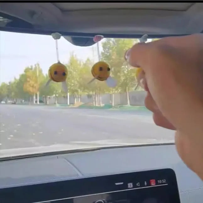 Soft fur bee car decoration on a swing spring for dashboard personalisation.