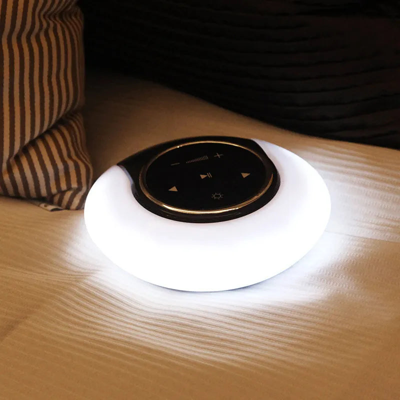 Folding Bluetooth speaker desk lamp with touch controls showing white, yellow, and blue LED lighting options