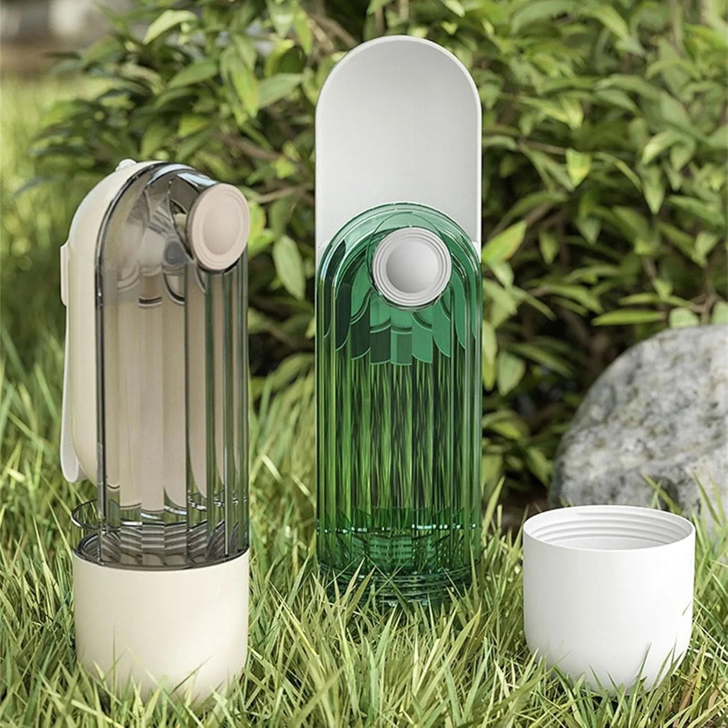 Beige and green foldable dog water bottle with food dispenser base for outdoor walking and travel.