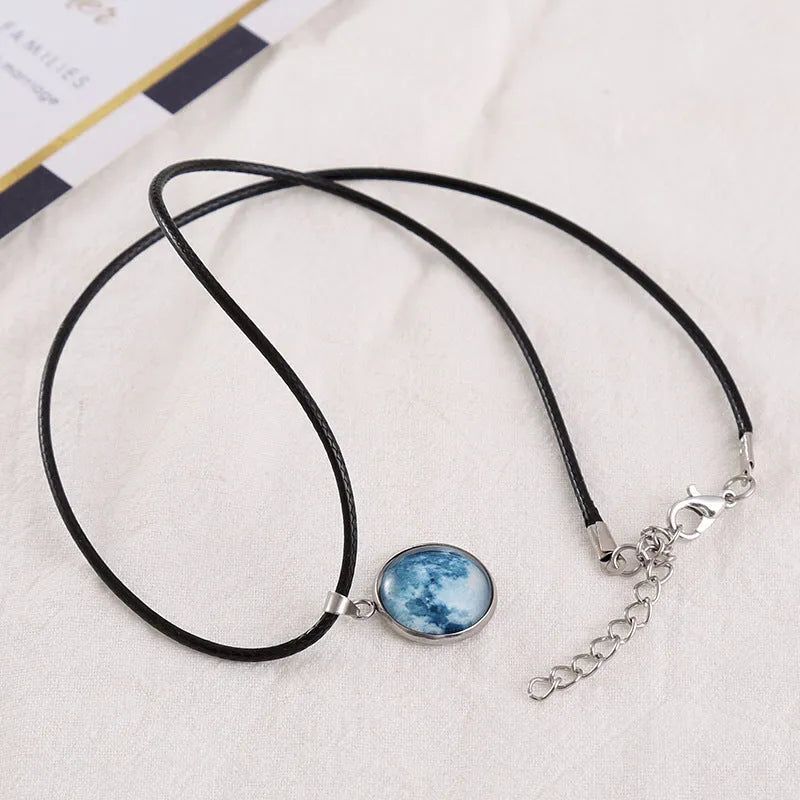 Luminous Christmas moon and night sky pendant necklace with adjustable chain on display