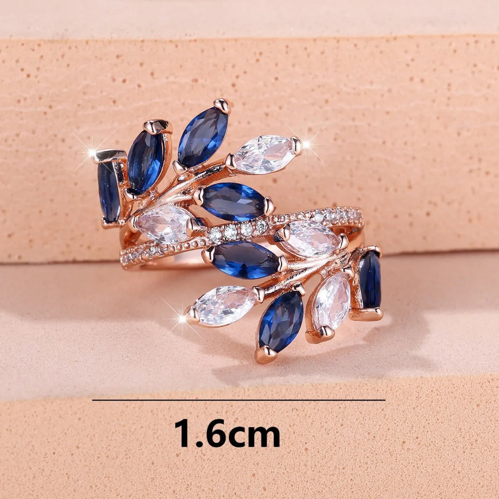Copper leaf-shaped ring with adjustable band and central horse eye zircon stone in a choice of colours.