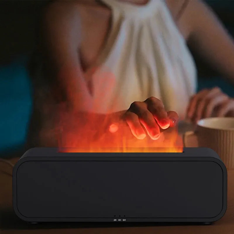 Black and white aroma diffuser with remote control on a table, showing colour-changing LED lights.