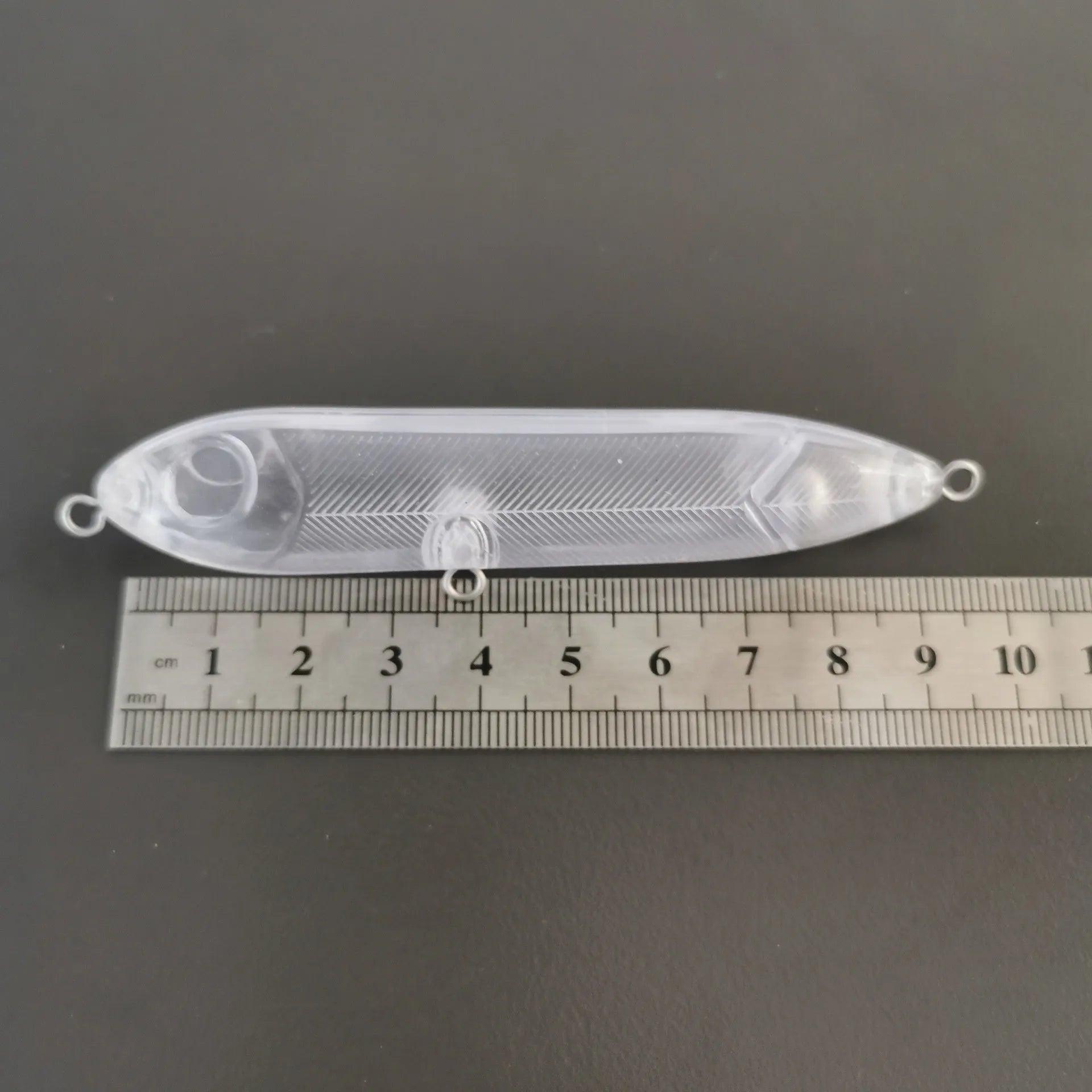 Transparent 9.5cm blank fishing lure body with pre-drilled 7mm eye holes for DIY assembly.