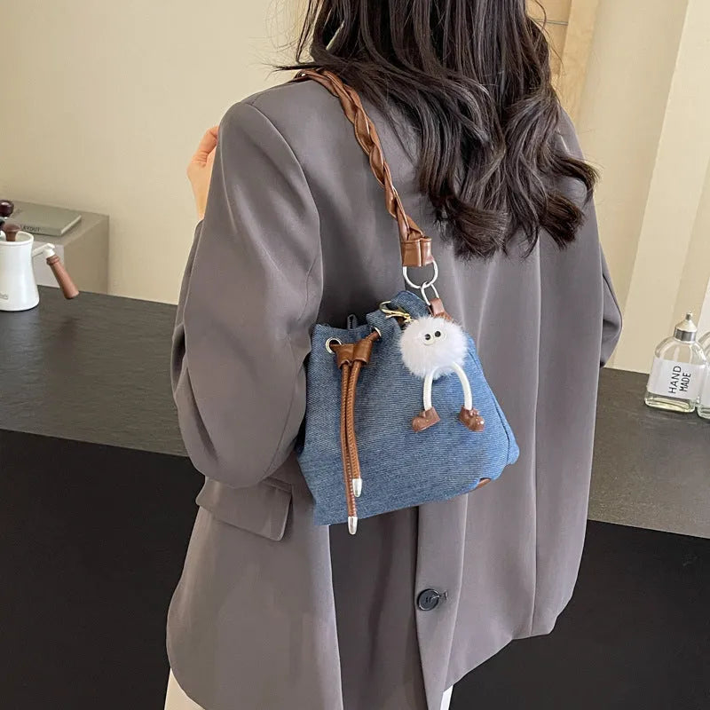 Blue one-shoulder cross body bucket bag with synthetic leather lining and sandwich pockets