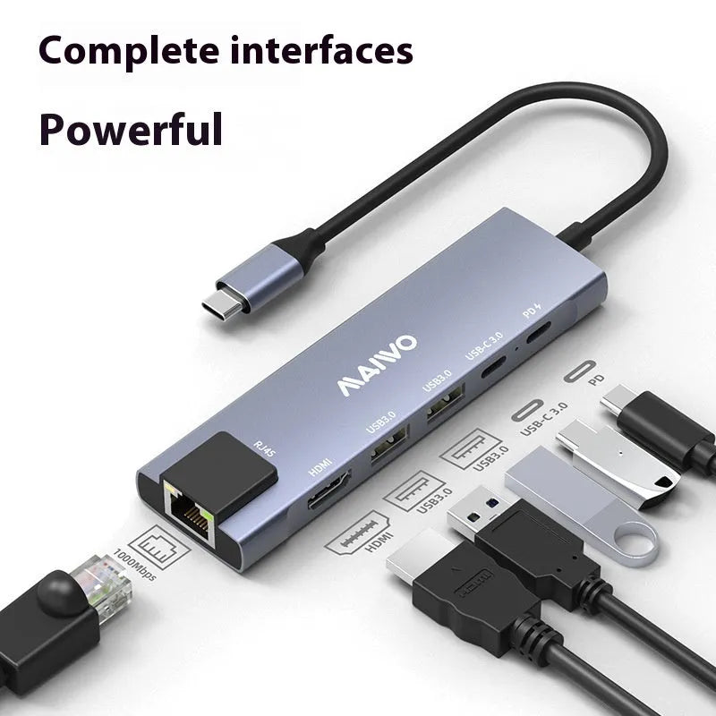 Aluminium Steam Deck six-in-one docking station with HDMI, USB, and Ethernet ports next to a handheld console.