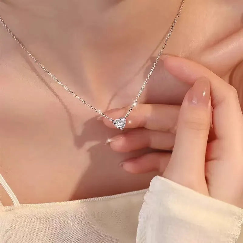 Silver-coloured women's necklace with a simple heart-shaped pendant on a chain.