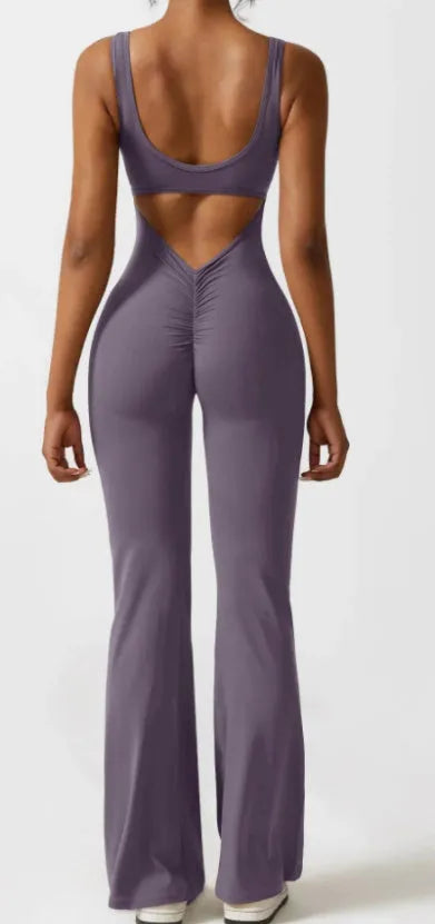 Women's tight black yoga bodysuit with seamless hollow design and trousers length.