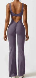 Women's tight black yoga bodysuit with seamless hollow design and trousers length.