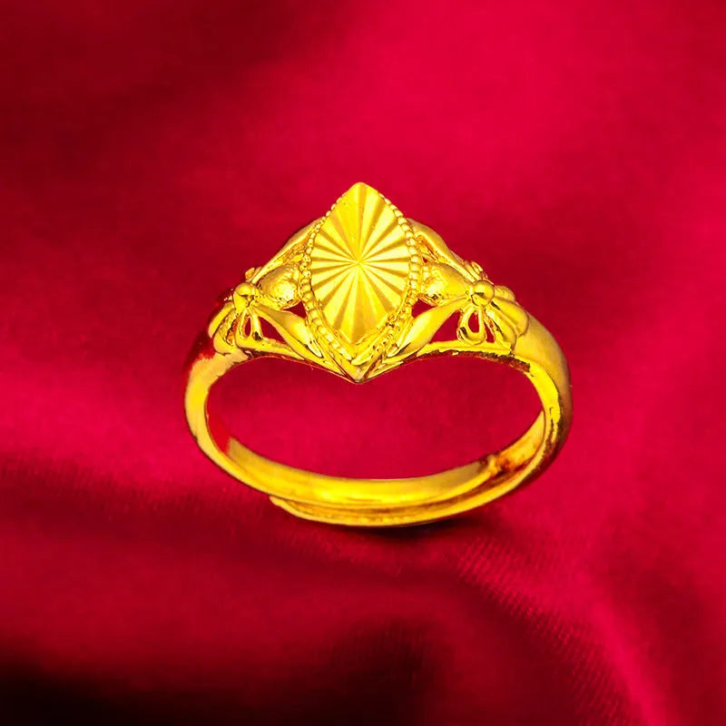 Geometric gold flower ring with open setting and textured details on brass base