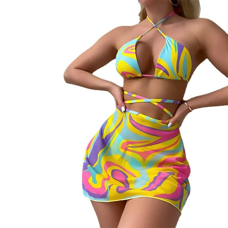 Yellow striped halter swimsuit for women with lace-up front, matching skirt, and shorts.