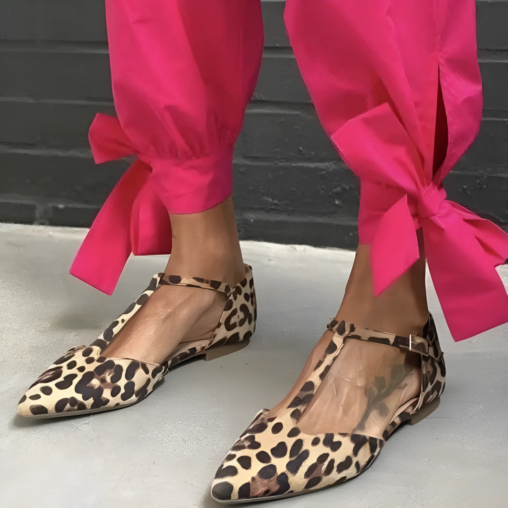 Women's leopard print pointed toe pumps with a low chunky heel and ankle straps.