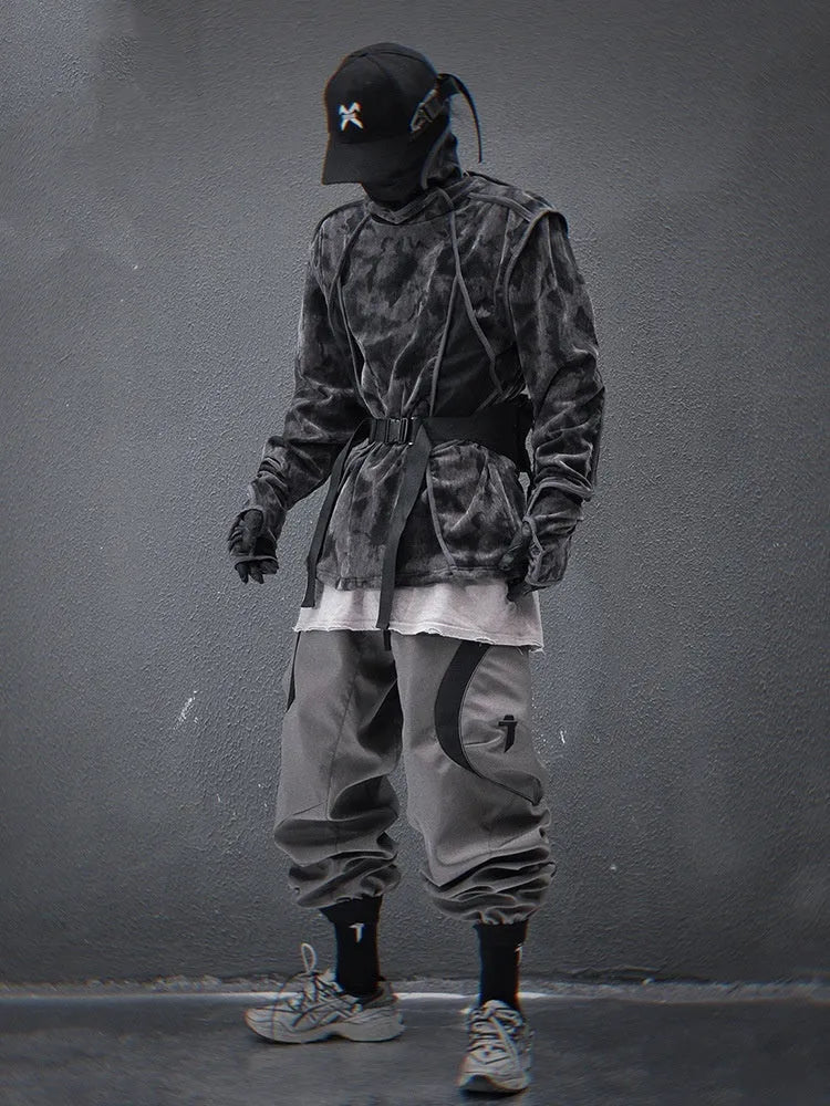 Men's black tie dye patterned pullover sweater with turtleneck and drop shoulders on a grey background.