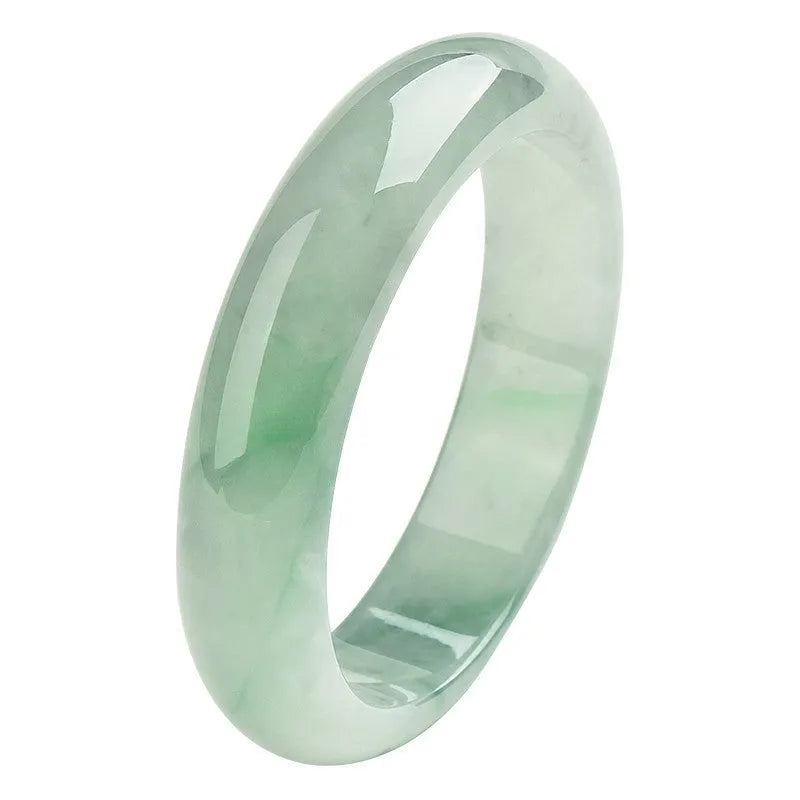 Natural light green jade bracelet on a wrist, showing unisex design and stone detail.