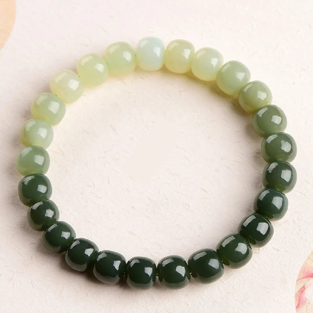 Natural Hetian jade bracelet with water gradient colour on a wrist.