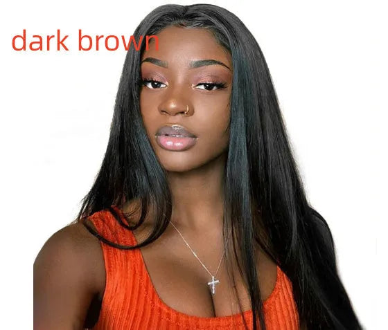 A woman wearing a long straight black synthetic wig with a centre-parted fringe.