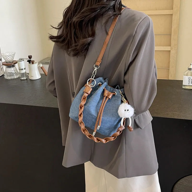Blue one-shoulder cross body bucket bag with synthetic leather lining and sandwich pockets