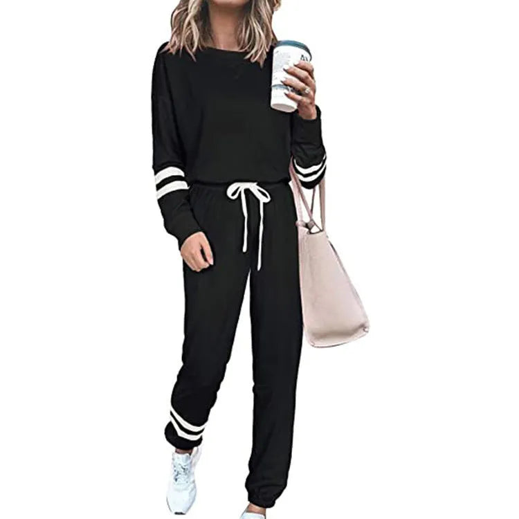 Women's loose-fitting plus size casual suit in a solid colour, featuring a half-sleeve top and trousers.