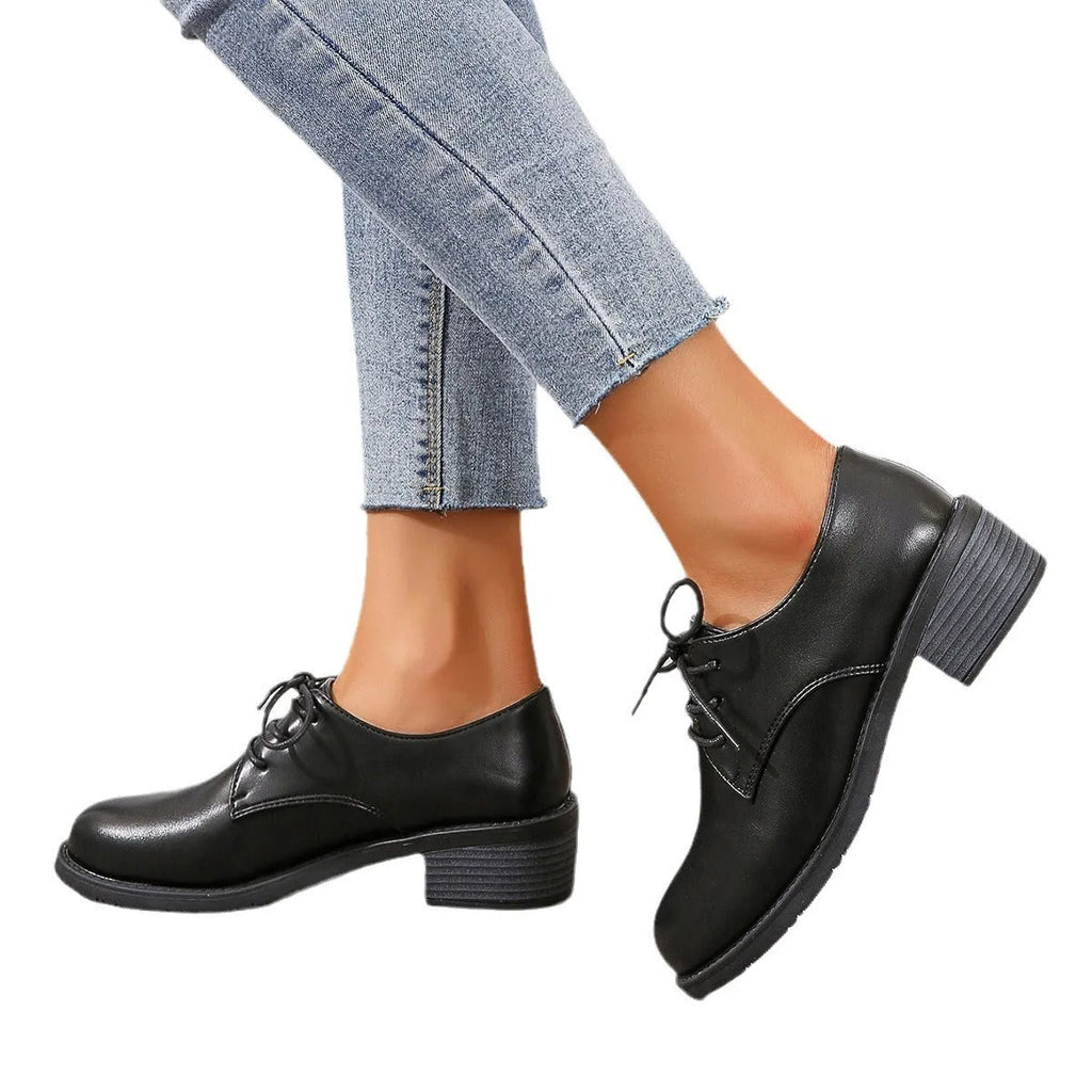 Black women's low-top PU leather shoes with a chunky mid-heel and pointed toe.