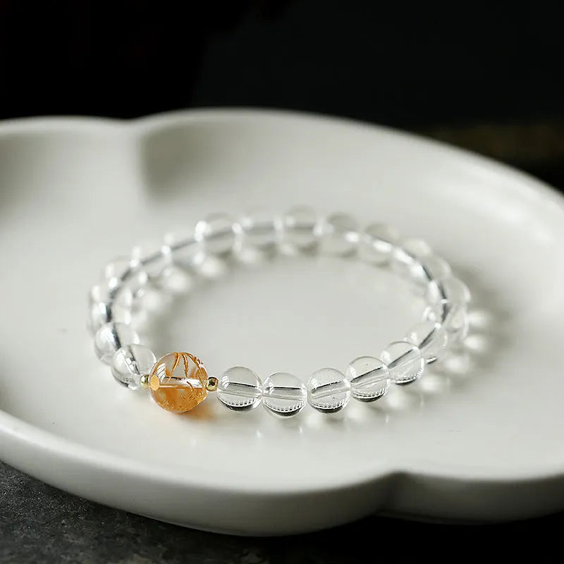 Unisex geometric beaded bracelet with obsidian, white crystal, and a gold dragon bead on a black background