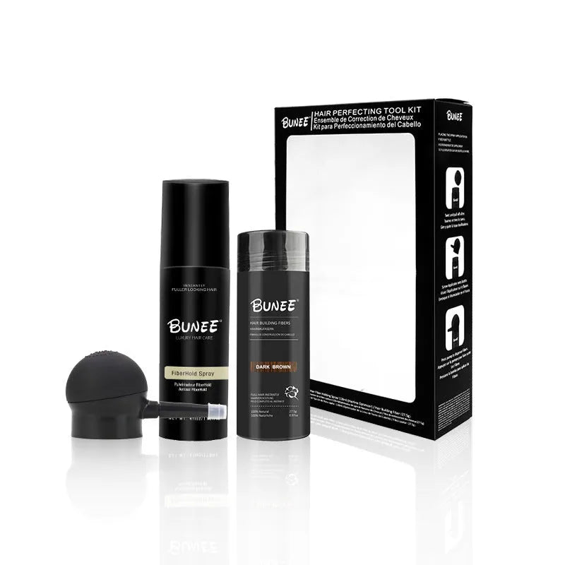 Boxed set of hair building fibre powder, styling spray and nozzle for volumising thin hair.