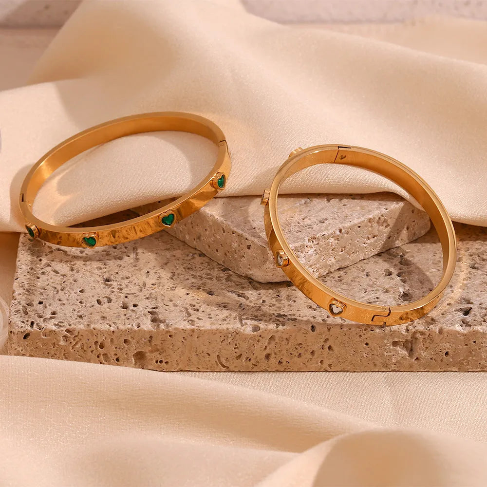 Stainless steel peach heart bracelet for women in a golden electroplated finish.