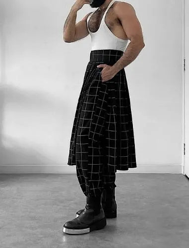 Man wearing grey plaid trousers with a contrasting darker apron panel across the front