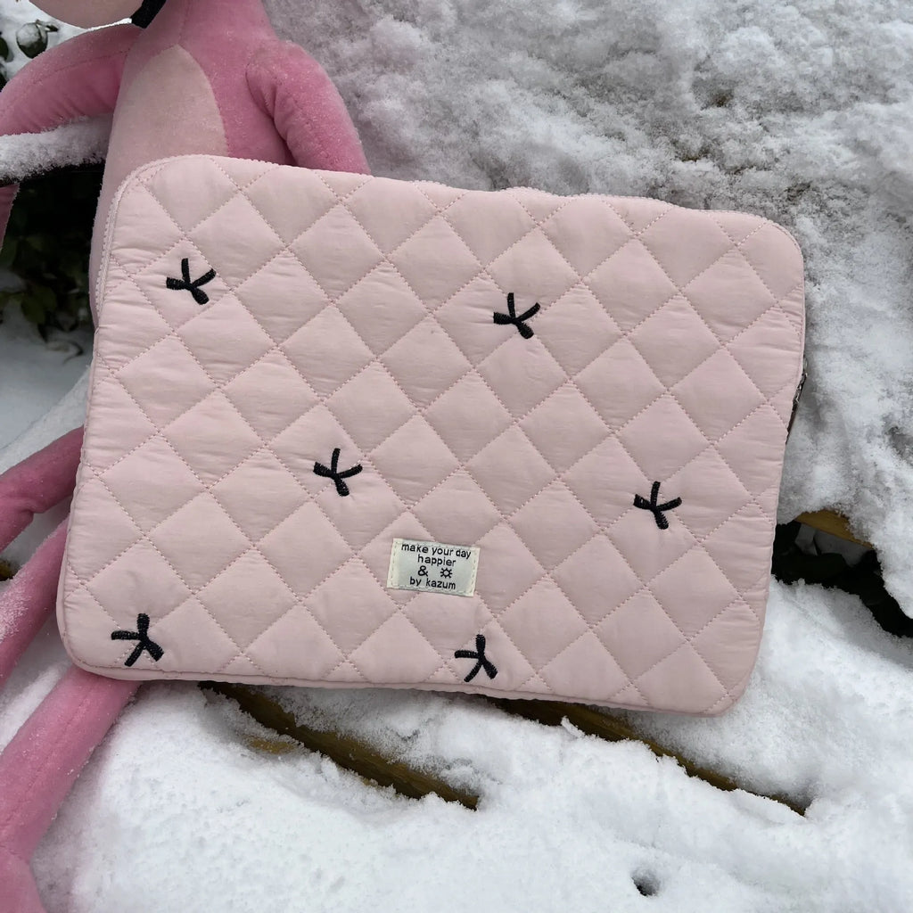 Nylon laptop storage bag with embroidered rhombus and bow design in light blue.