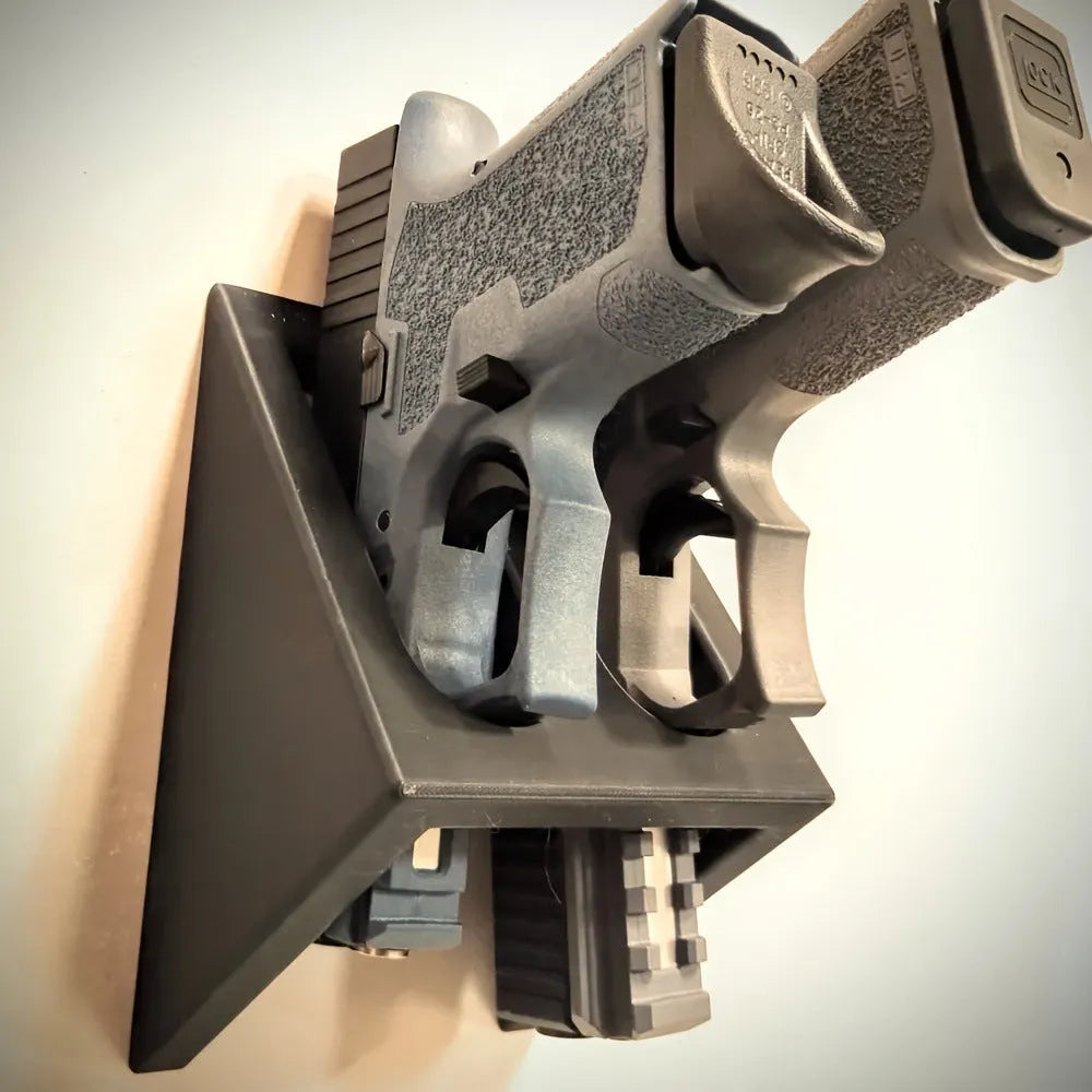 Black plastic pistol display stand for model firearms measuring 10.85 by 7.6 centimetres