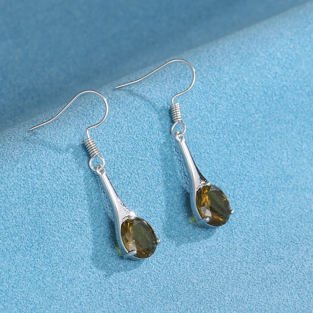 Olive green drop shape fashion earrings with a retro minimalist style.