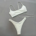 Solid colour split women's swimsuit in nylon, sleeveless one-piece, available in brown, beige, and black
