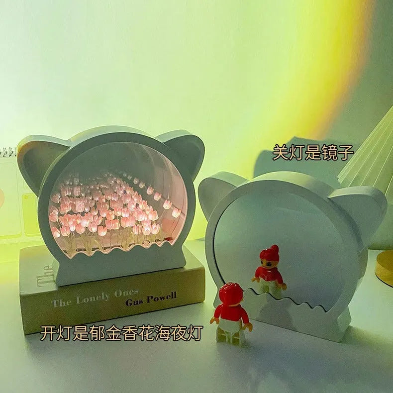 Handmade DIY cat head shaped night lamp decorated with pink tulip flowers on a dark background