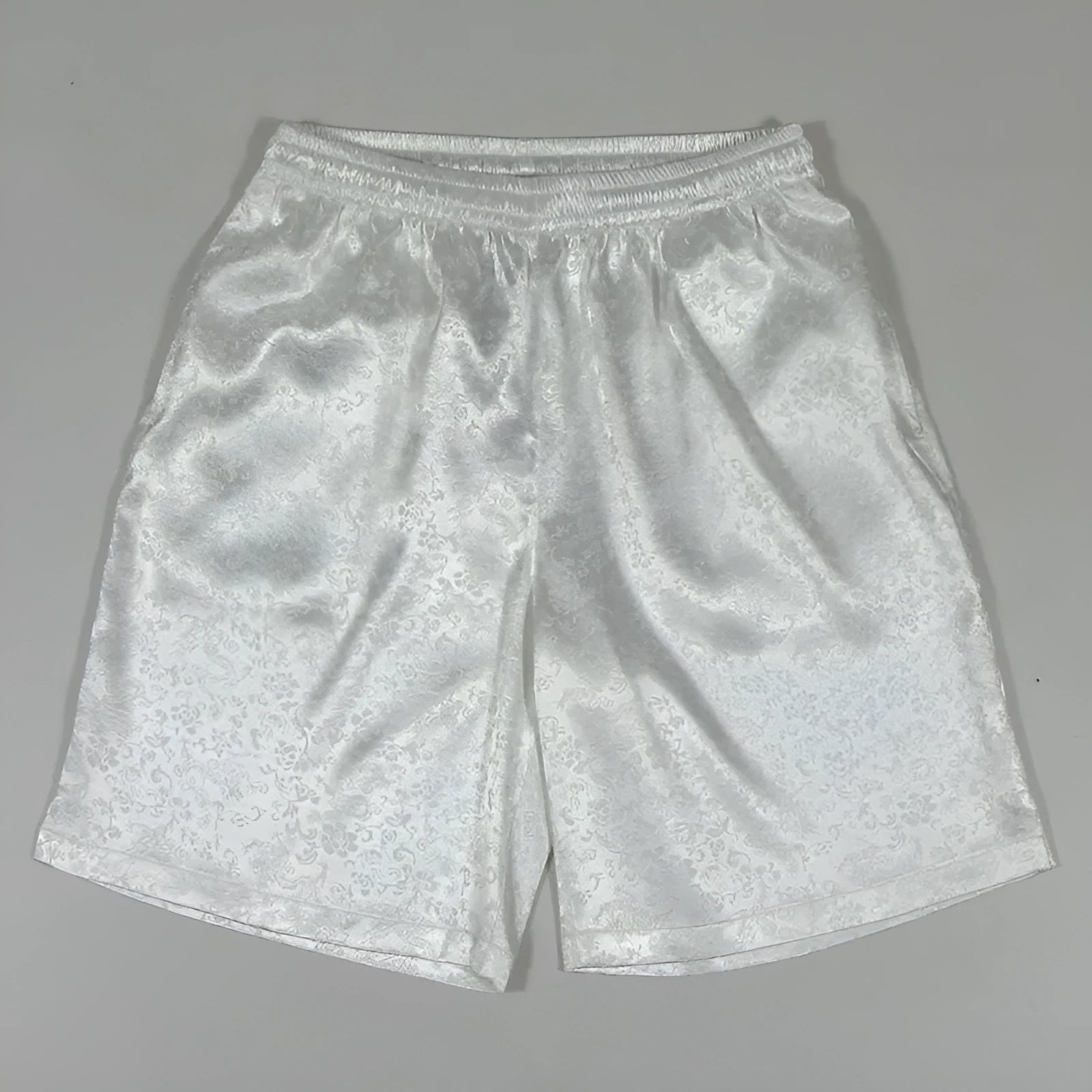 Man wearing black Tang suit style elastic waist shorts for martial arts training.