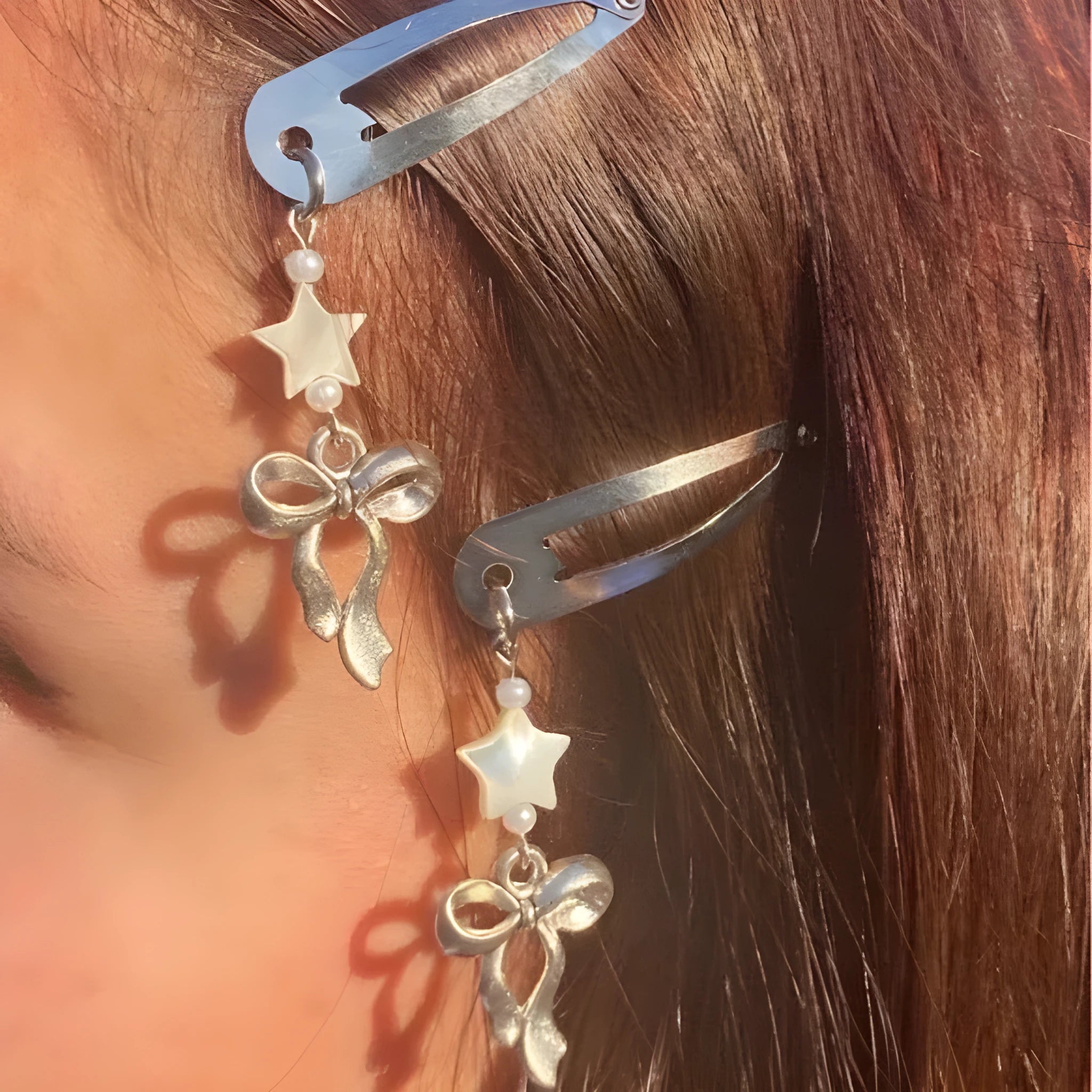 Silver metal alloy star bow hair clip with electroplated finish on neutral background