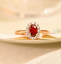 Sterling silver ring with gold pigeon design, floral pattern and red blood gemstone accents