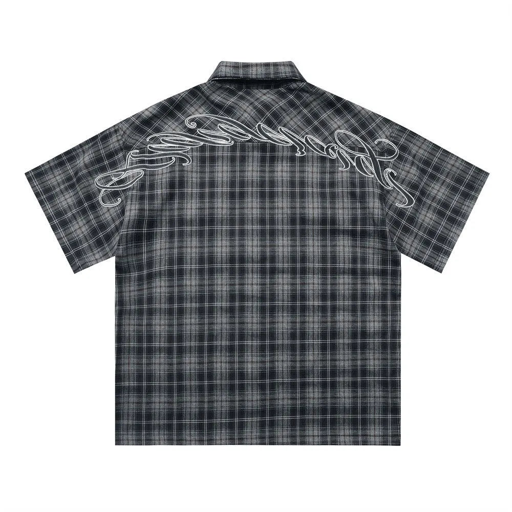 Men's black plaid shirt with embroidered letter detailing and short sleeves