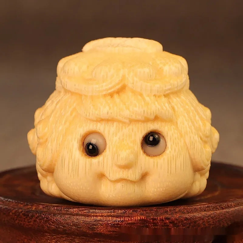 Solid bamboo carved golden toad princess ornament on display.
